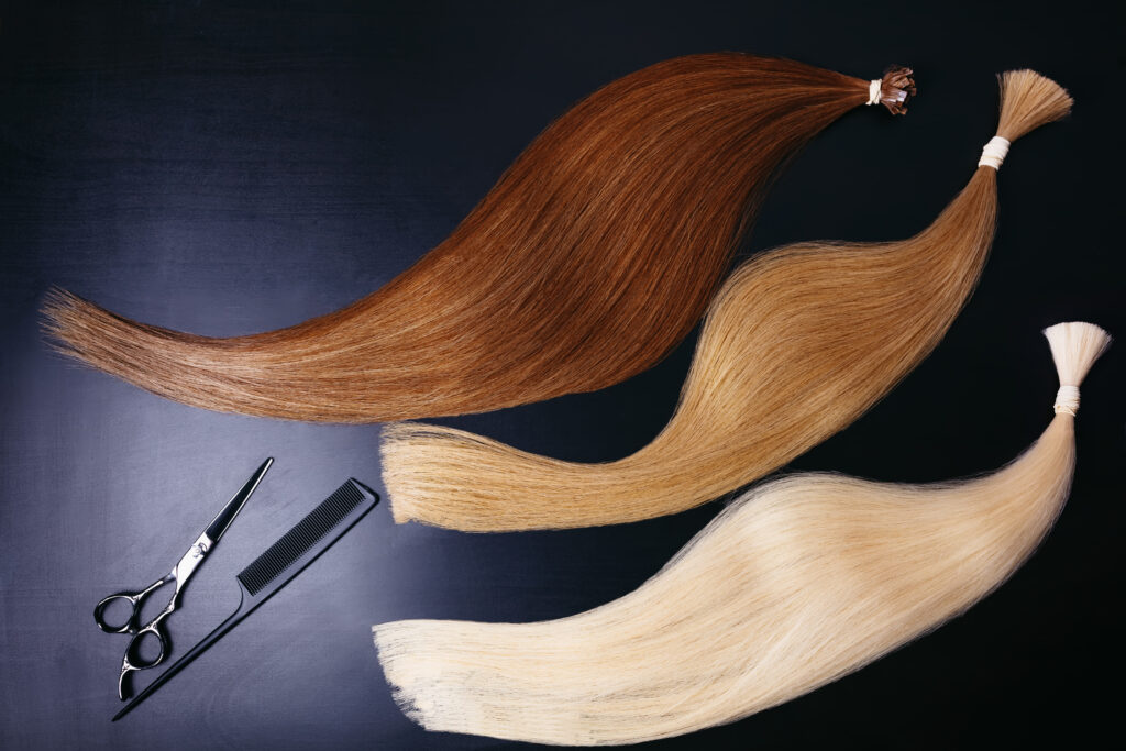 hair extensions of three colors on a dark background